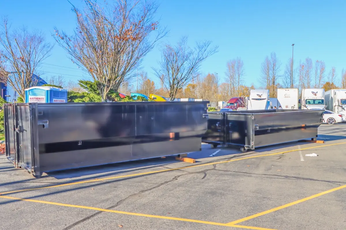 Professional dumpster rental service with roll-off container on residential driveway in Vandalia